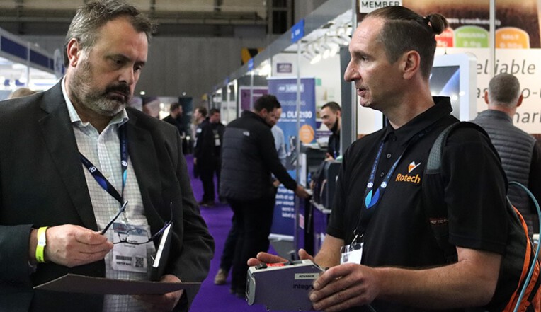 Member of customer support team talking to customer at PPMA show