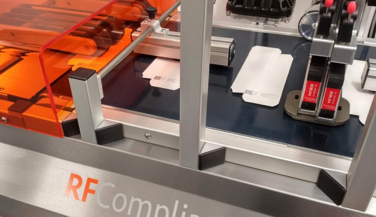 RF Compliance with camera system and medical cartons running along the conveyor