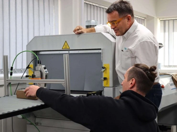 Service engineer demonstrating thermal inkjet technology to customer