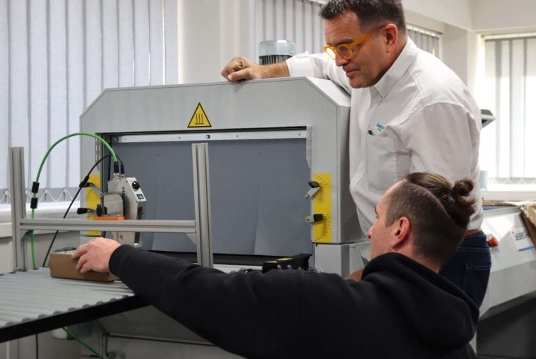 Service engineer demonstrating thermal inkjet technology to customer