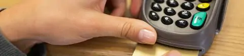  Hand inserting card into card machine