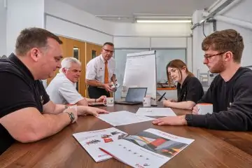 Rotech team talking round a meeting table