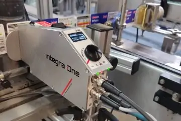 Thermal Inkjet printer on a milk bottle production line. Printing onto whole milk labels