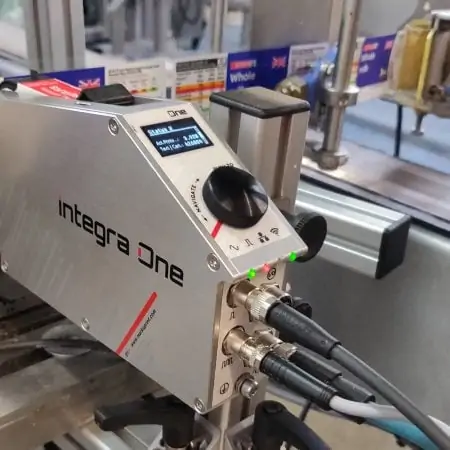 Thermal Inkjet printer on a milk bottle production line. Printing onto whole milk labels