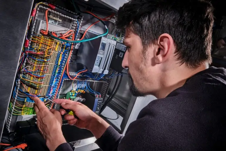 Rotech engineer working on the wiring in a RF Compliance