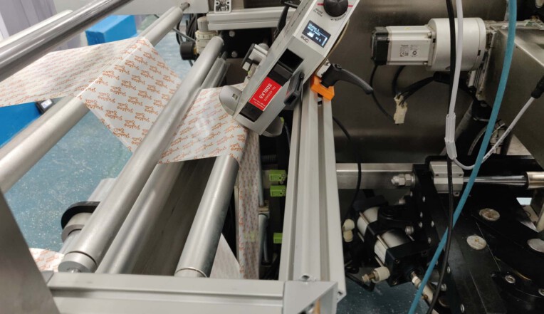 Thermal inkjet printer integrated into flow wrapping machinery