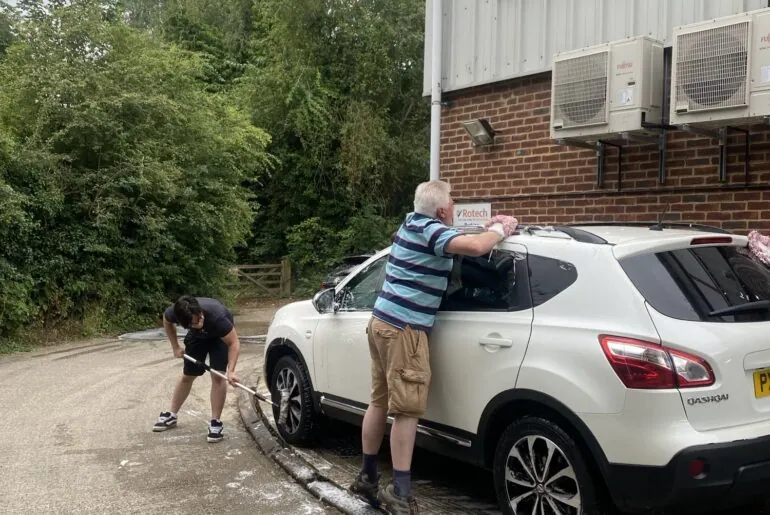 miguel and richard washing the car